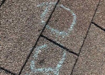 Chalk drawing of a simple stick figure on a brick pavement.